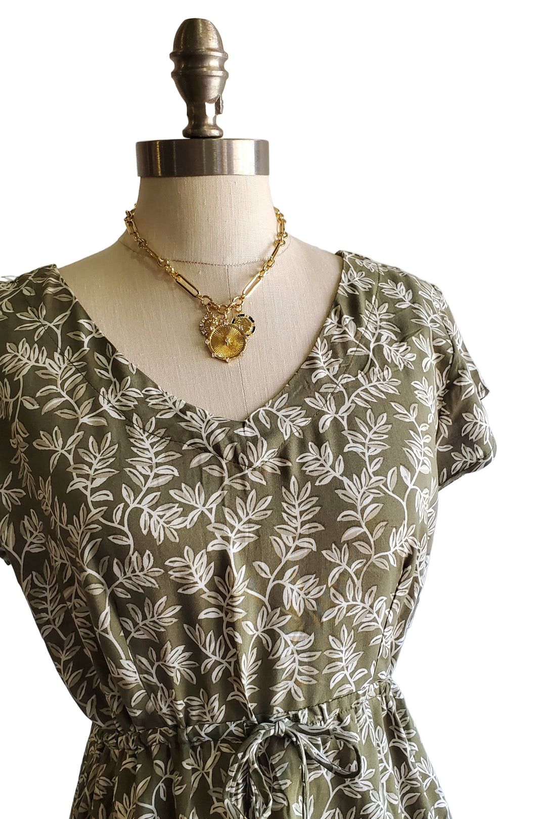Floral dress on a mannequin against a plain background