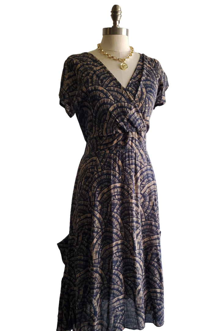 Patterned dress on a mannequin against a plain background